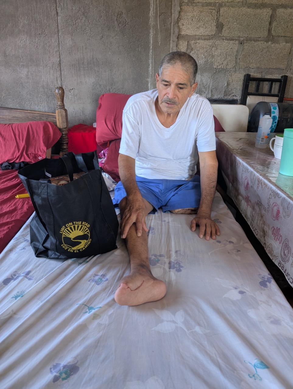 A man seated beside a Light On The Road care package