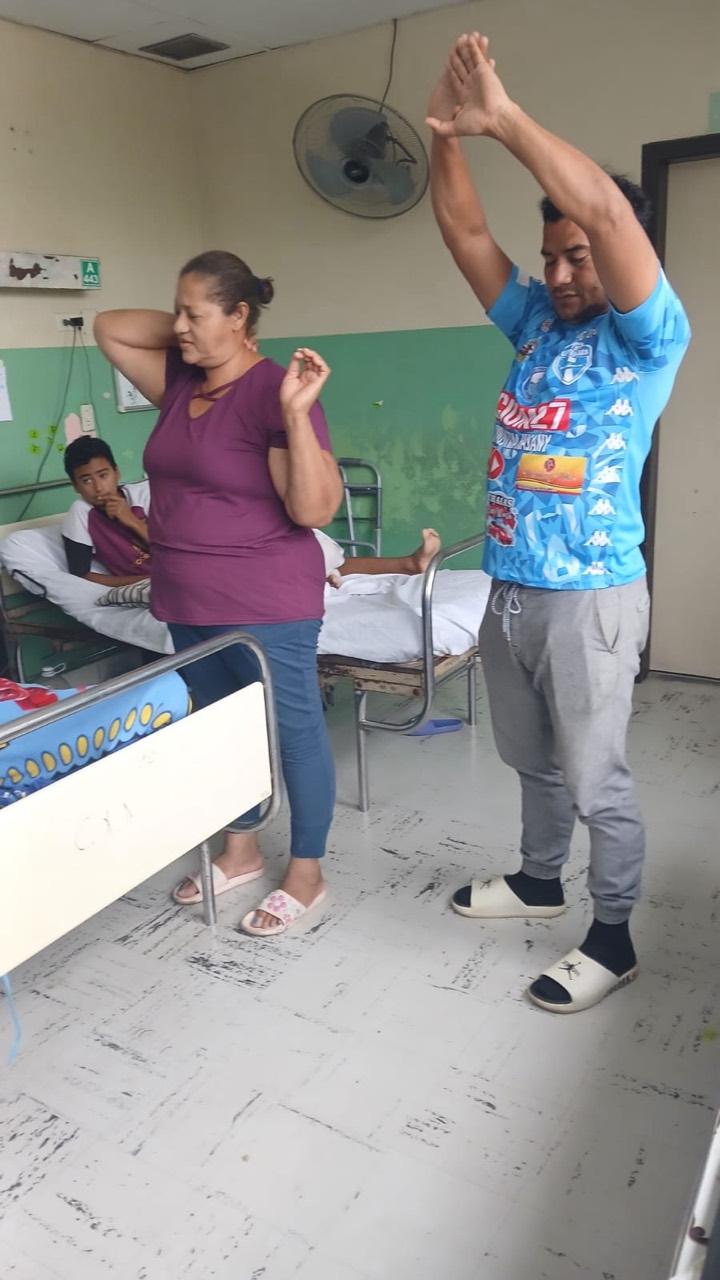 Family members praying together in a hospital room