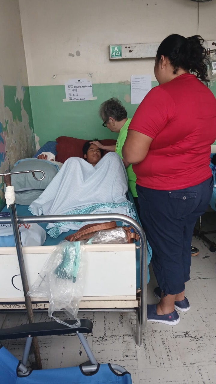 Rosa comforting a young patient during a hospital visit